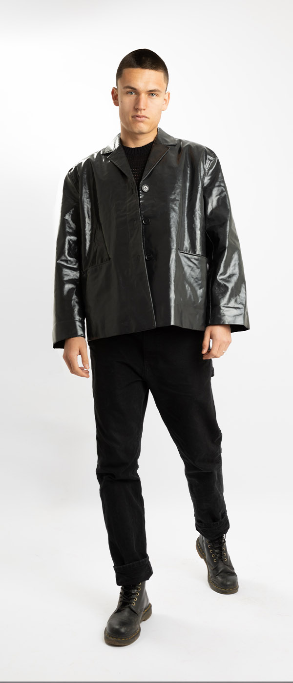Male model in black jacket against white background